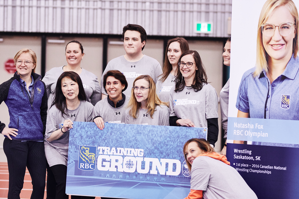 A photo of Natasha Fox posing with athletes at an RBC Training Ground event