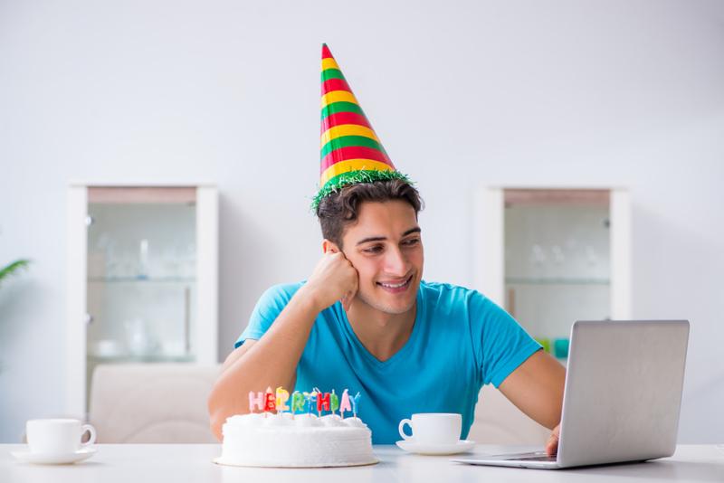 Young man celebrating birthday alone at home