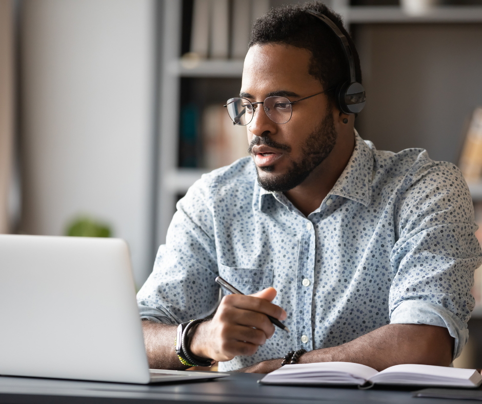 A person watches a webinar on a laptop