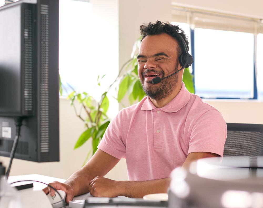 A person wearing a headset works in an office.
