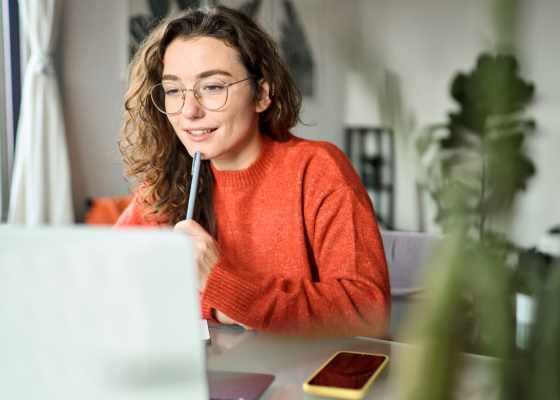 A person uses a laptop to participate in a webinar.