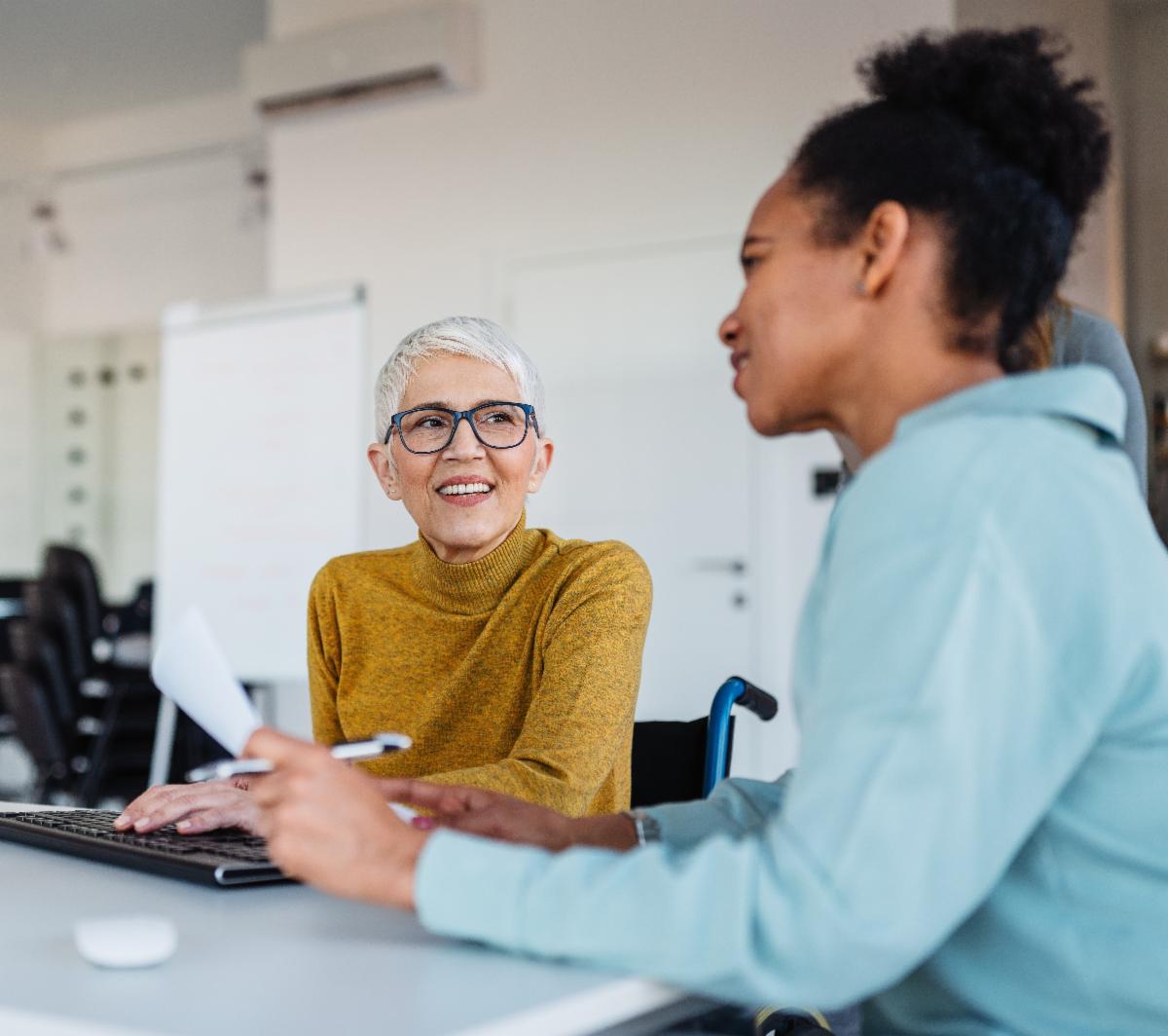Two women working in an office setting.