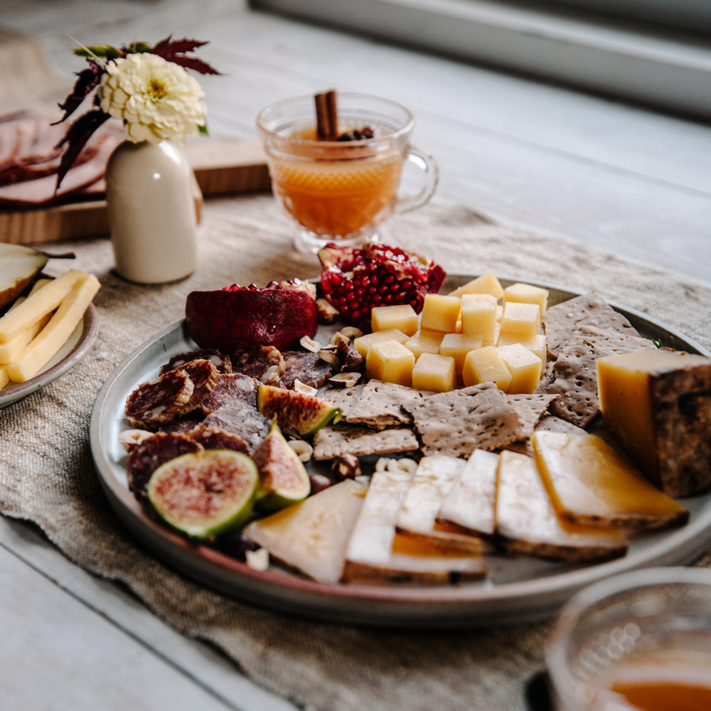 A festive holiday tablescape with cheese and fruit