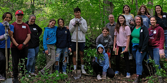 A slideshow of images depicting groups of children and adults in indoor and outdoor learning spaces