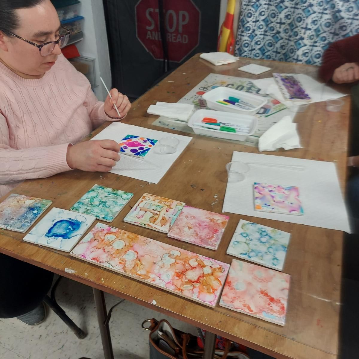 Patron working on tiles from Workshop Wednesday