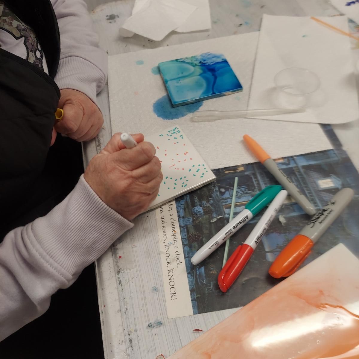 Patron working on a tile from Workshop Wednesday