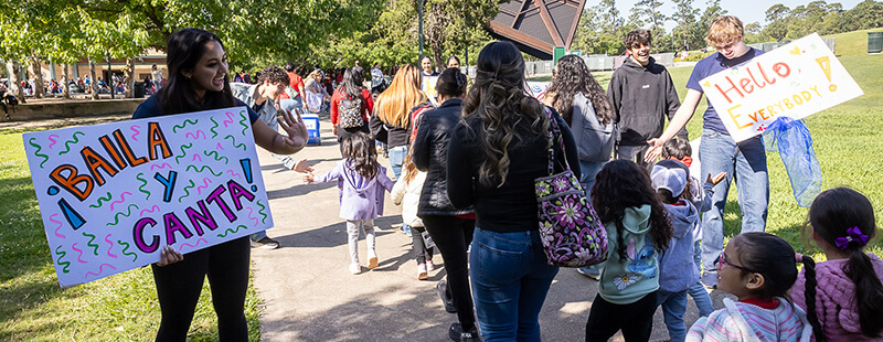 Prelude Music Concert teachers greeting families and children as they walk up