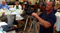 Photo of Bruce Bohannan setting-up video equipment.