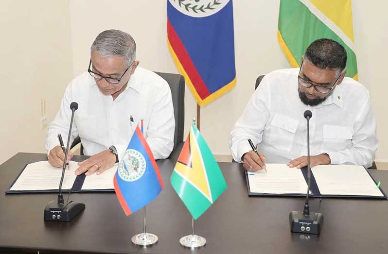 Following the formal addresses at the Belizean National Assembly for a special Joint Sitting of the House of Representatives and the Senate, President Dr. Irfaan Ali and Belize Prime Minister John Briceño inked several Memoranda of Understanding (Government of Belize Press Office photo)