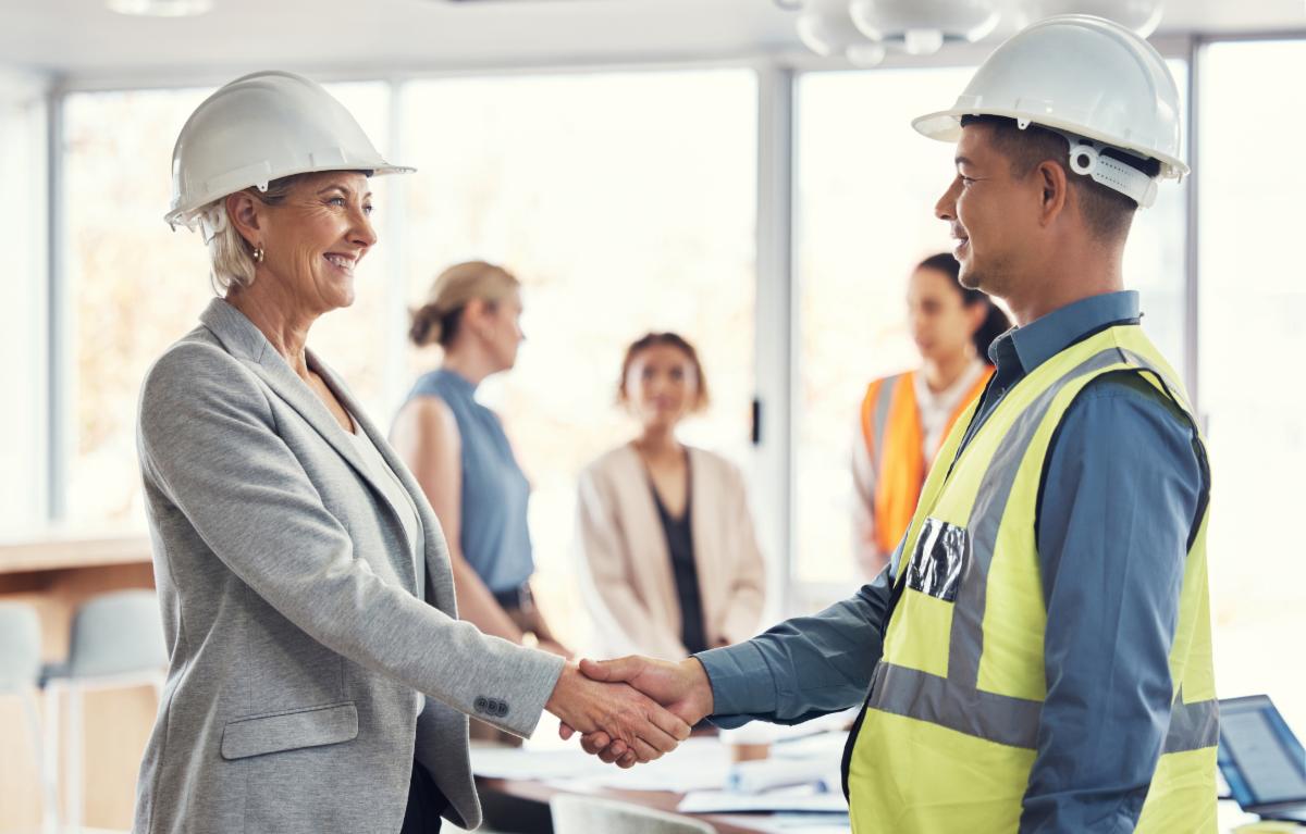 Collaboration happy and engineering with handshake of people in office for architecture b2b or contract. Partnership meeting and shaking hands with employee for designer construction or agreement