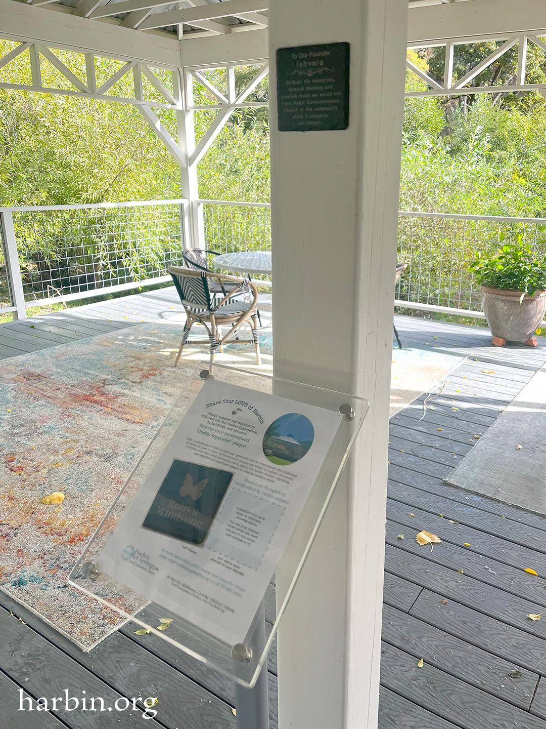 Inside the open air new pavilion structure are beams that hold the roof. The new commemorative plaques are afixed onto the beams. This image shows one plaque, the first to be installed.