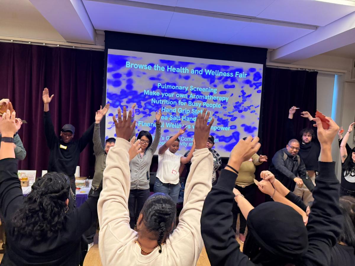 A crowd of people are waving their arms in the air like they are trees in the breeze.