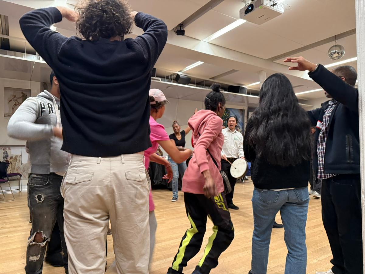 A crowd of people are moving around in a room. 