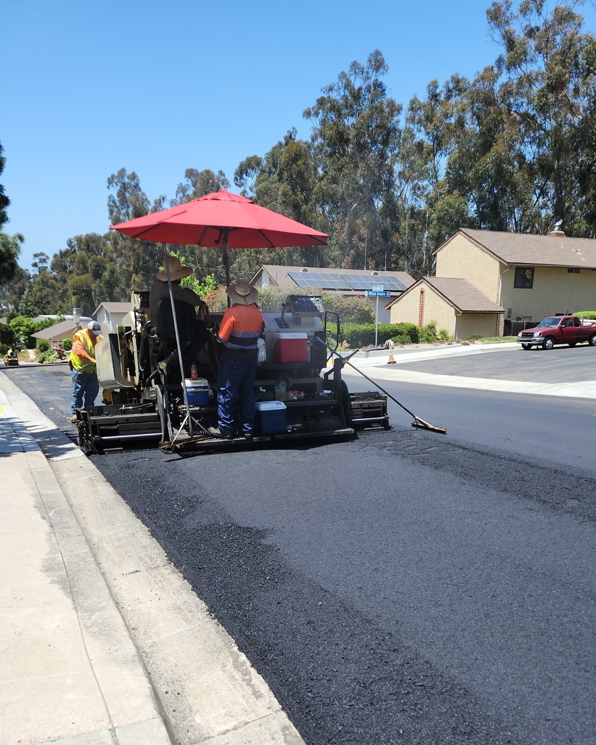 Construction crews overlaying city street.