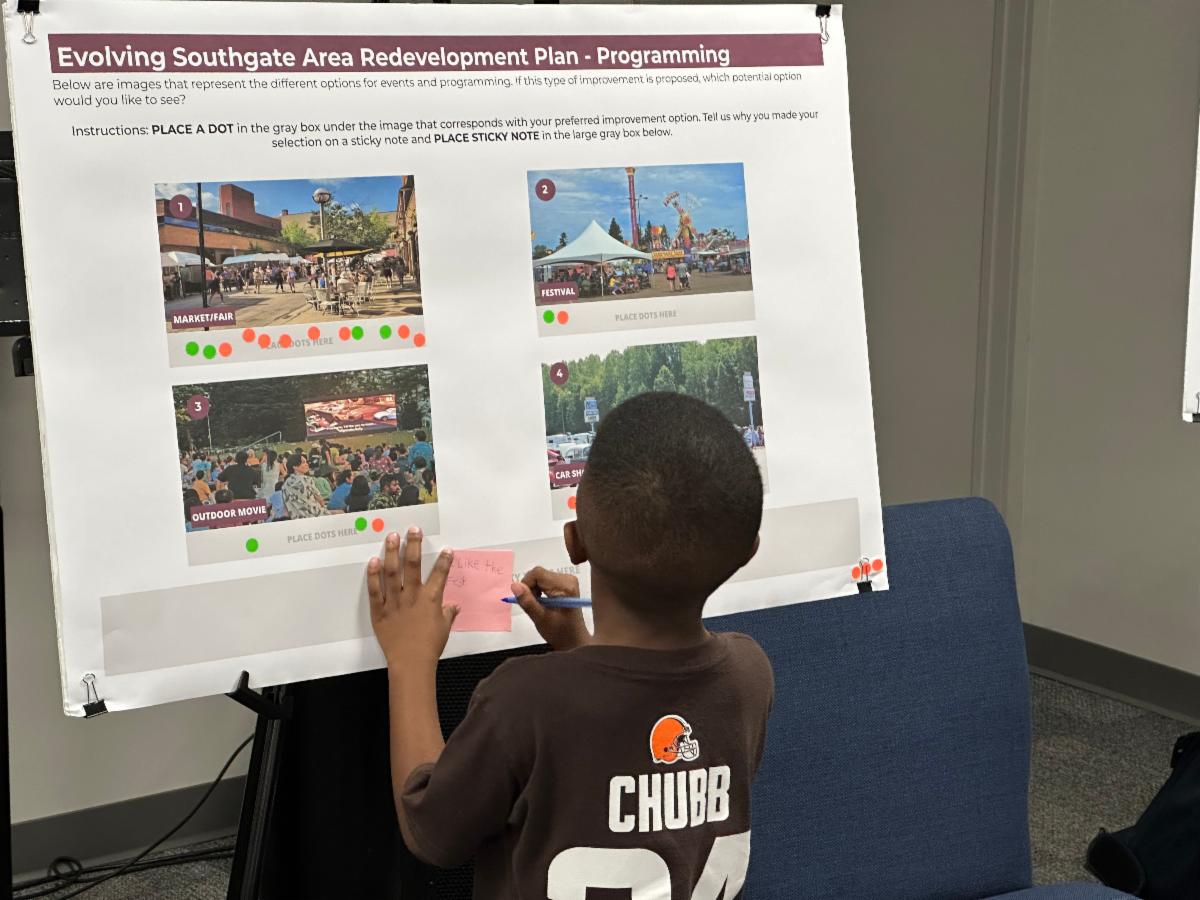 a boy sharing his ideas at a public meeting