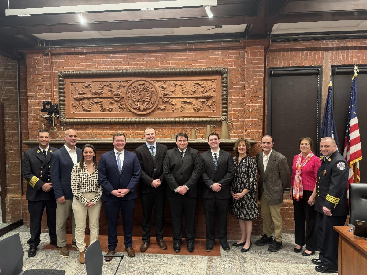 Picture of new Wellesley firefighters, fire chief, assistant chief, and Wellesley Select Board members