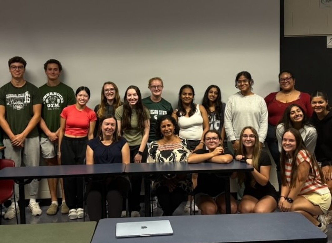 Meet the Deans event. Dean C. and Associate Dean Leon smile with 15 SAC members