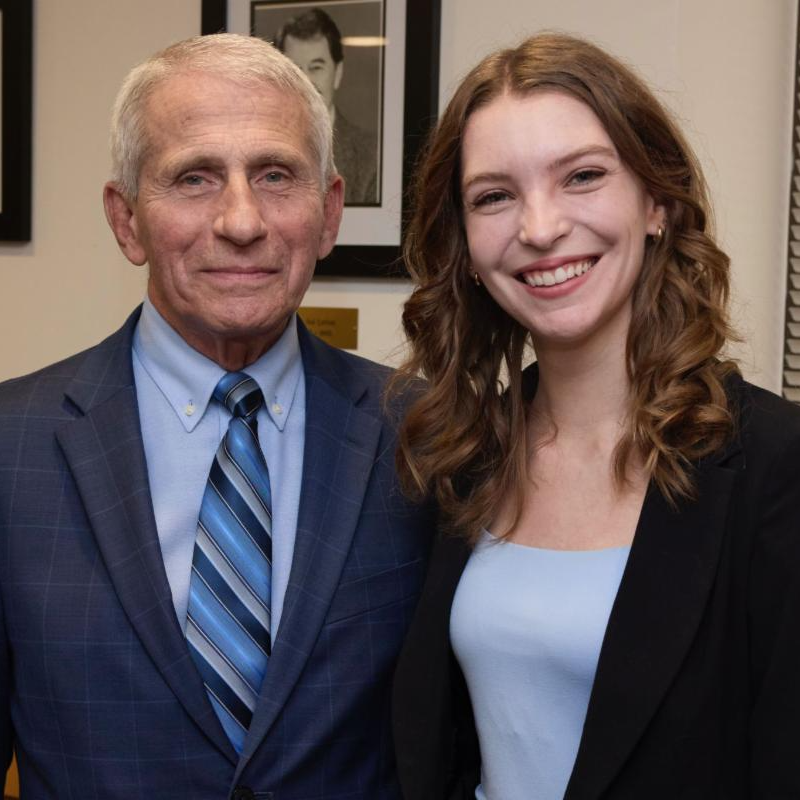 Dr. Anthony Fauci poses with Bailey Bowcott. Both smile.