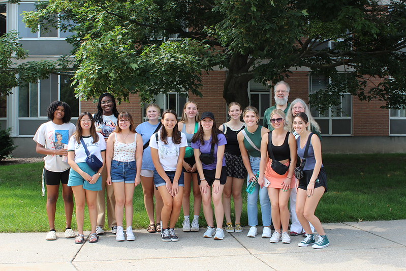 A group of first-year students smiles and poses with Pat Merry and Don Borseth, who support this program