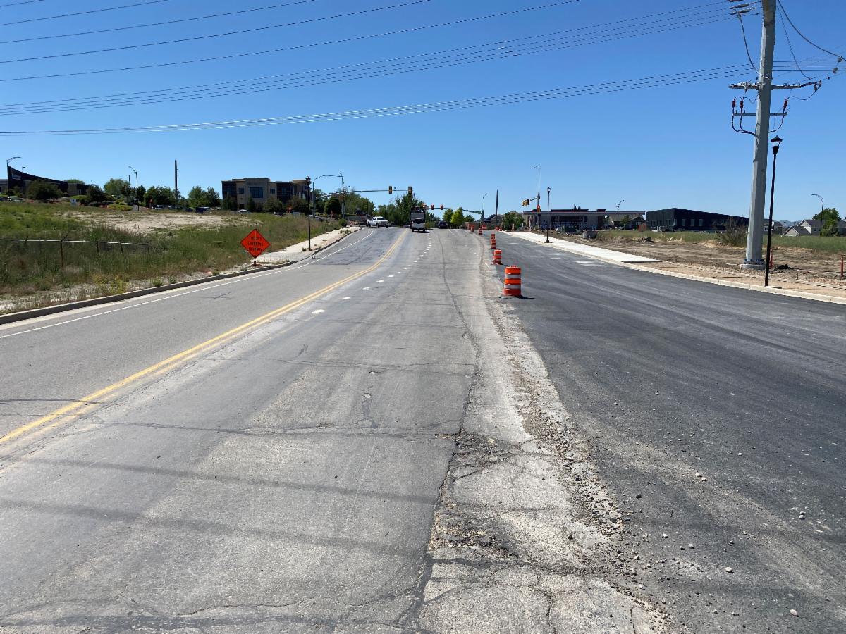 Crews have finished the bottom layer of asphalt and will install the final top layer next week. New sidewalks are also visible on the right side of the photo.