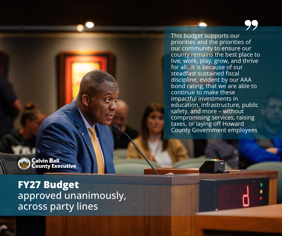 Graphic with a photo of County Executive Calvin Ball seated at a microphone delivering his Fiscal Year 2027 to the Howard County Council with text about the budget being unanimously approved across party lines and its support Howard County's priorities.