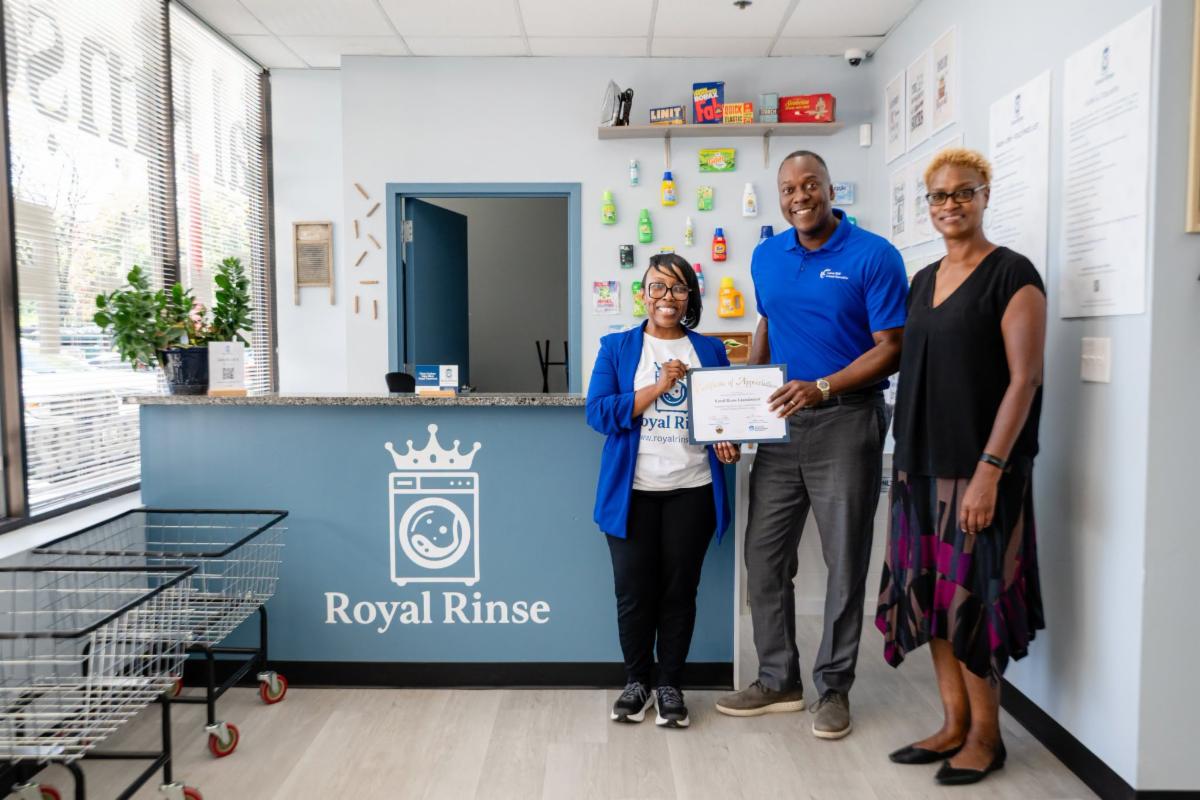 County Executive Calvin Ball posed for a photo inside Royal Rinse with a staff member and Howard County Economic Development Authority CEO Jennifer Jones. 