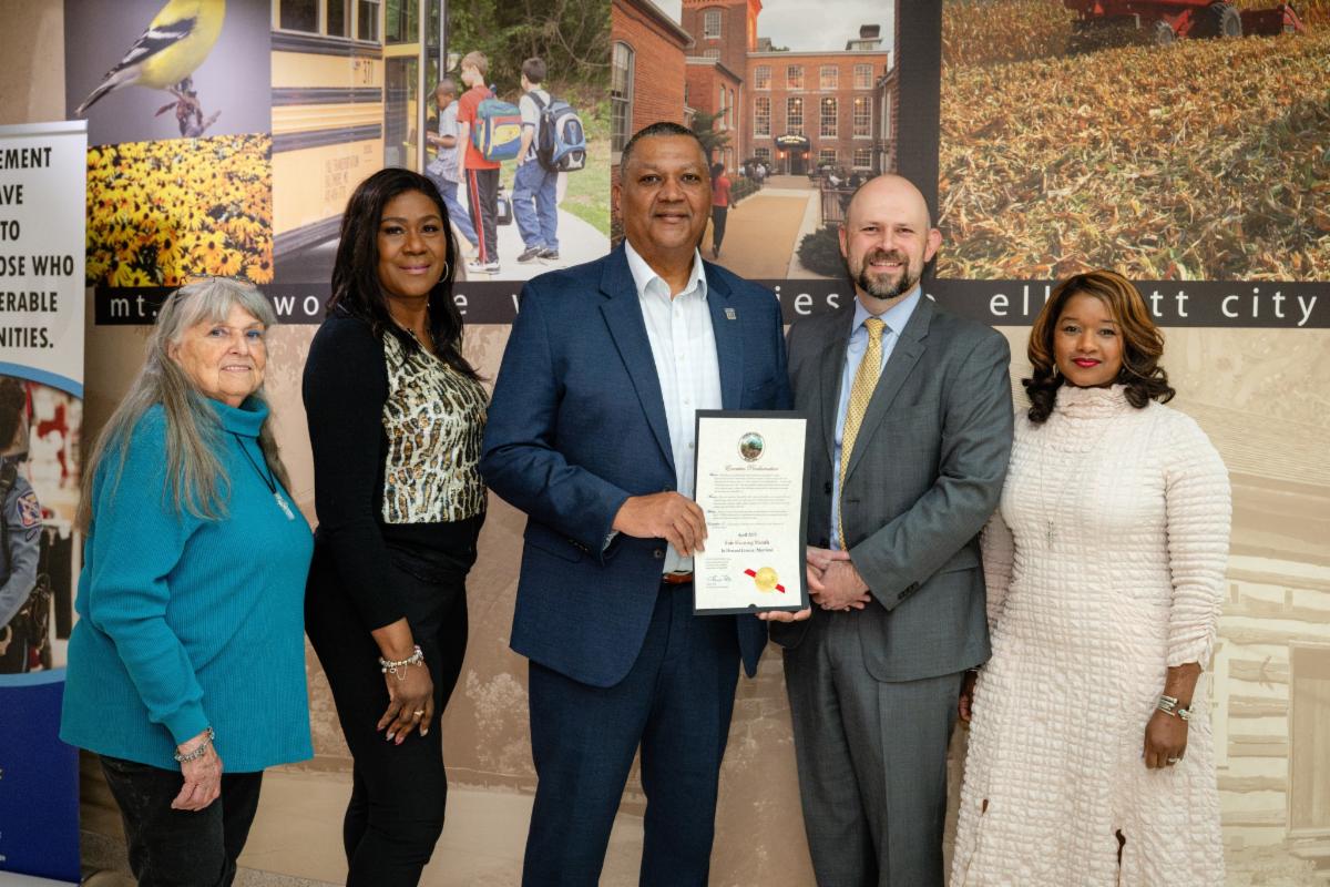 A photo of Deputy Chief of Staff Brian Shepter with HCAR President Jimmie Jennings, Fair Housing Chair Joy Epps, and other proclaiming April "Fair Housing Month" in Howard County.