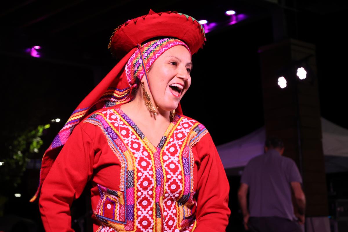 Woman in festive Hispanic dress and head ware. 