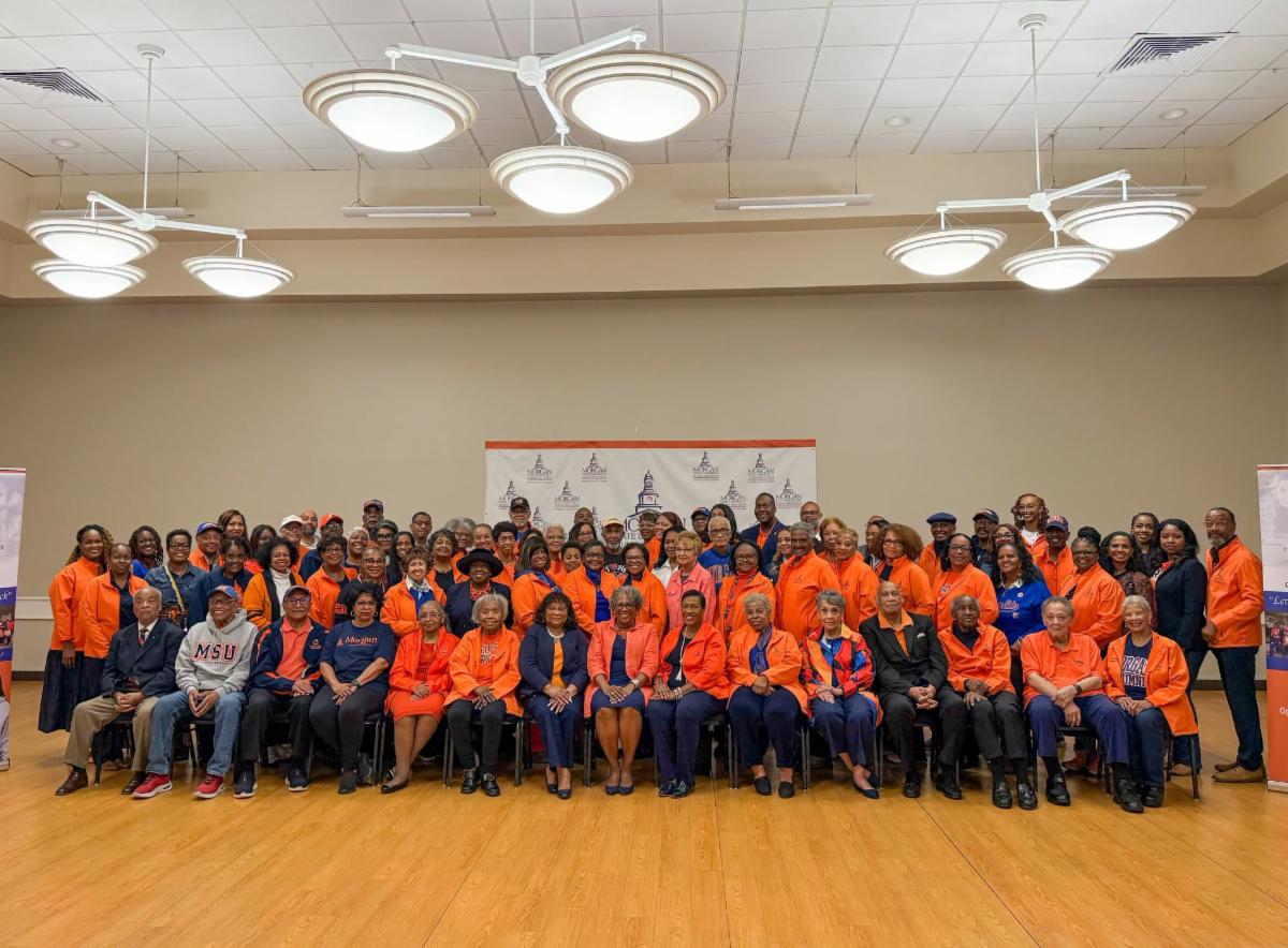 A photo of Calvin Ball posing with a large group of Morgan State Alumni Howard County Chapter.