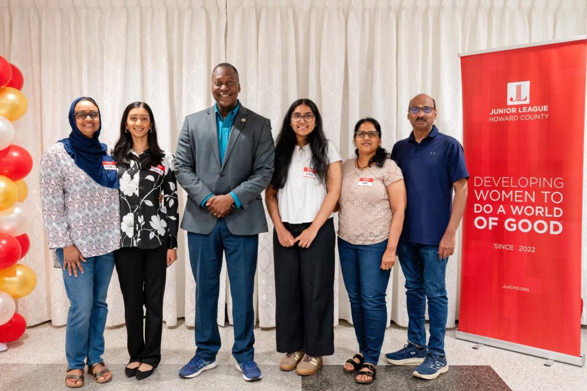 County Executive Calvin Ball posed for a photo with Junior League of Howard County Changemakers Scholarship Award winners.