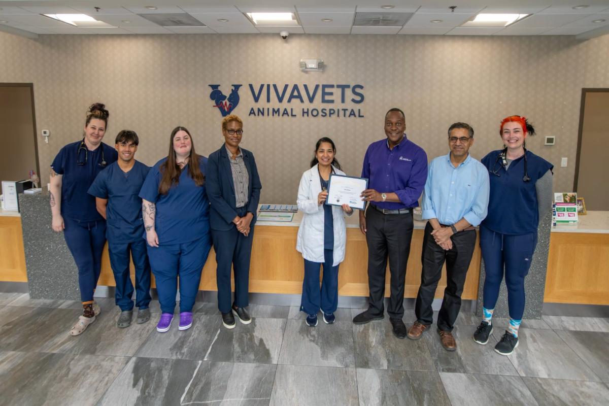 County Executive Calvin Ball posed for a photo inside VivaVets Animal Hospital and pictures with the facility founder and Medical Director Dr. Kanwaldeep Sharma and her staff and Howard County Economic Developemt Authority's CEO Jennifer Jones.