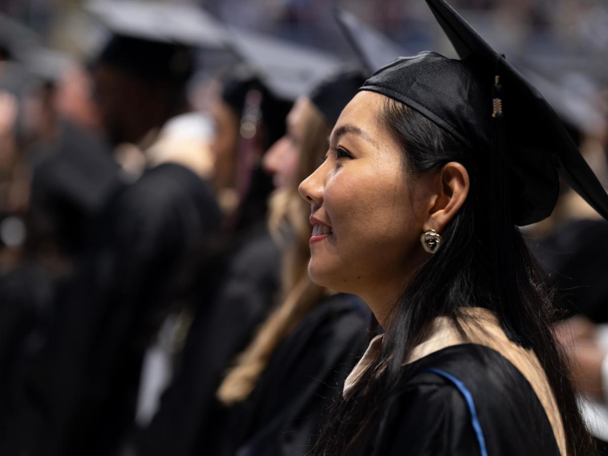 A young woman in a graduation gown