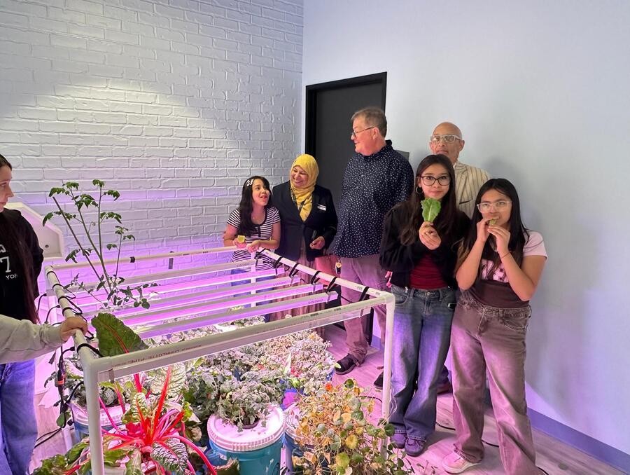 Shawn Kelly poses with his students and Associate Professor Most Tahera Naznin. 