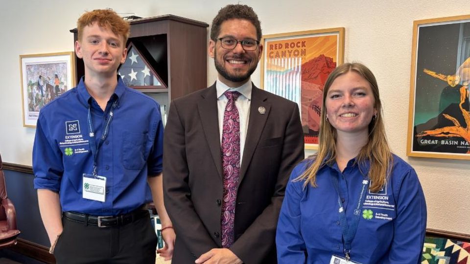 Two 4-H youth pose for a picture with Majority Whip Howard Watts in his office.