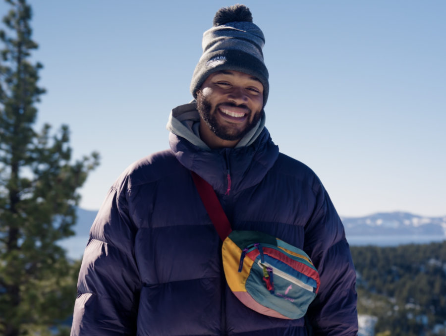 Deandre Presswood, bundled up against the cold, smiles from a snow-covered scenic overlook of Lake Tahoe.