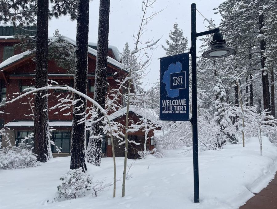 A snow-covered campus adorned with a banner: Welcome to the Tier 1 University at Lake Tahoe.