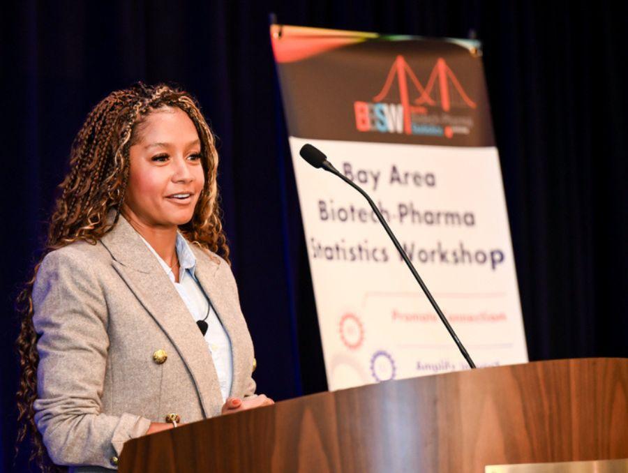 Dominique addressing a delegation in a corporate hall.