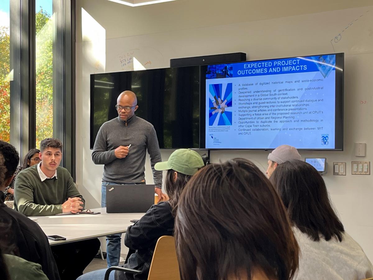 Prof. Mokhele (standing) visits MIT in October of 2023 to guest lecture on the topic and proposed research ideas.