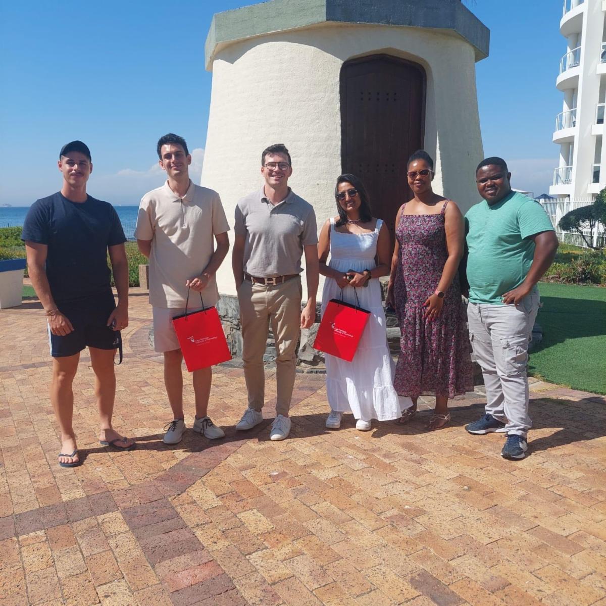 MCP ‘25 Students Mikel Sandin (second from left) and Shubhi Goyal (third from right) travel to CPUT during IAP 2024 to partake in the research project. 