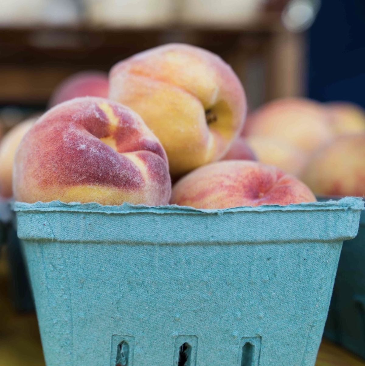 Michigan peaches inside a blue container
