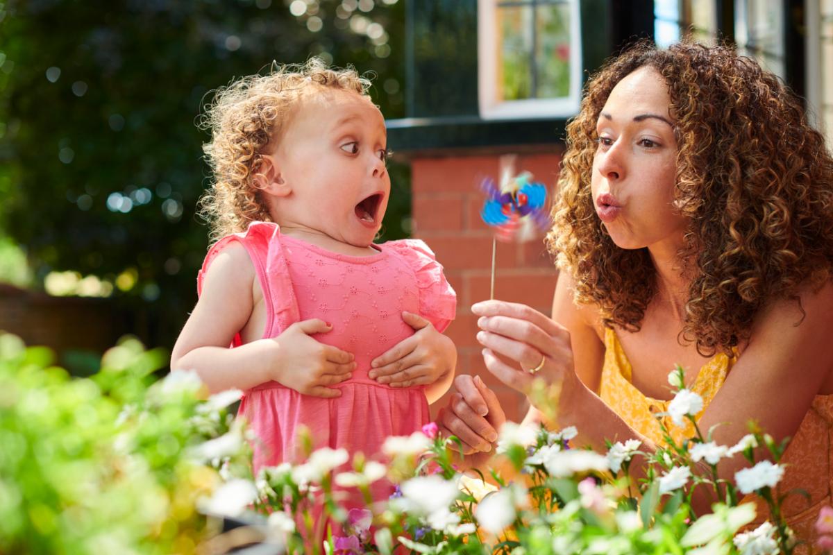 young woman and small child outdoors in garden