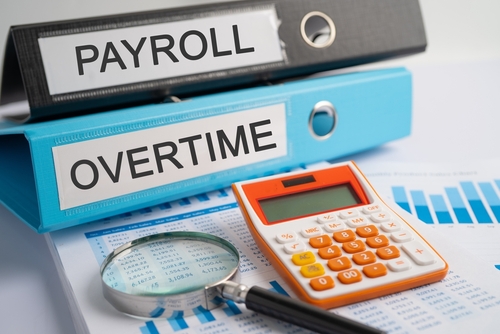 Payroll_ Overtime. Binder data finance report business with graph analysis in office.