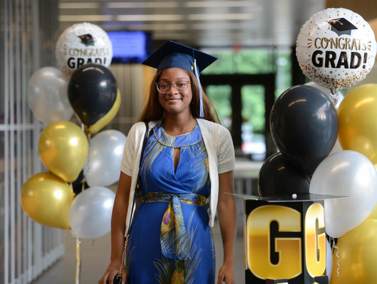 A Black high school student wearing a graduation cap surrounded by balloons at the Black Futures Celebration 2026