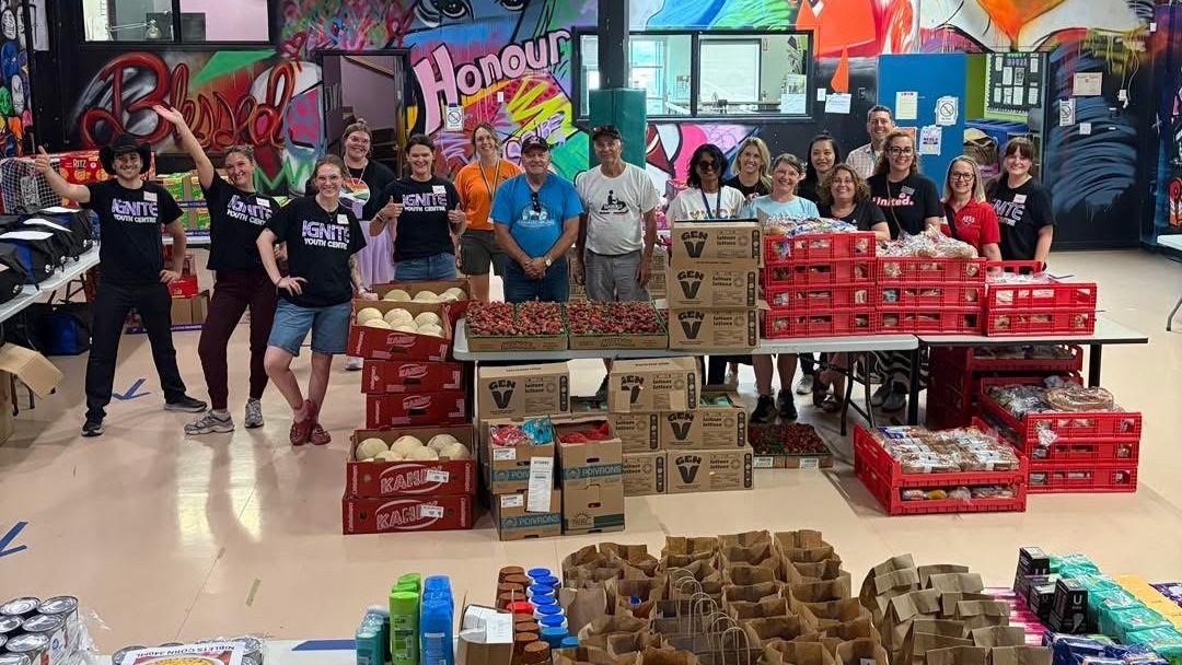 Boxes and shelves full of free groceries at the Ignite Youth Centre Free Community Market