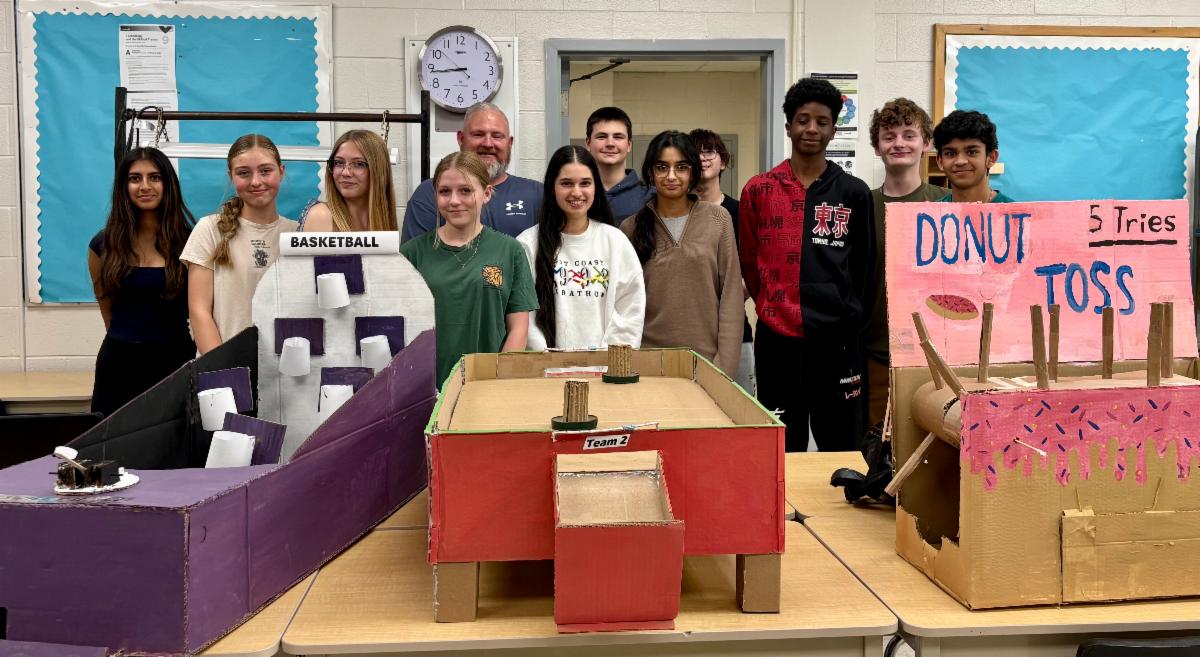 Students pose with arcade games