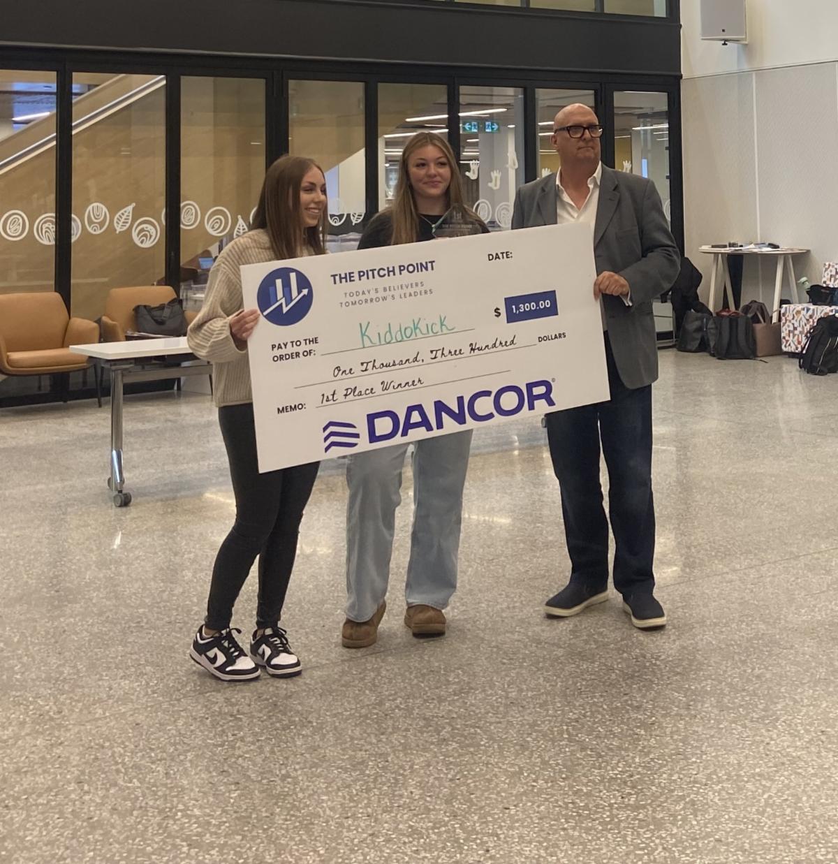 Winners of Point Point holding large cheque