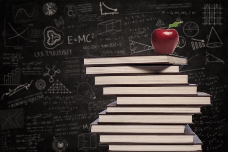 Red apple on a stack of books