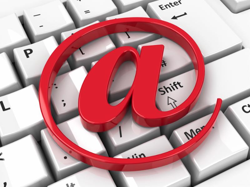 a red @ symbol on a white keyboard