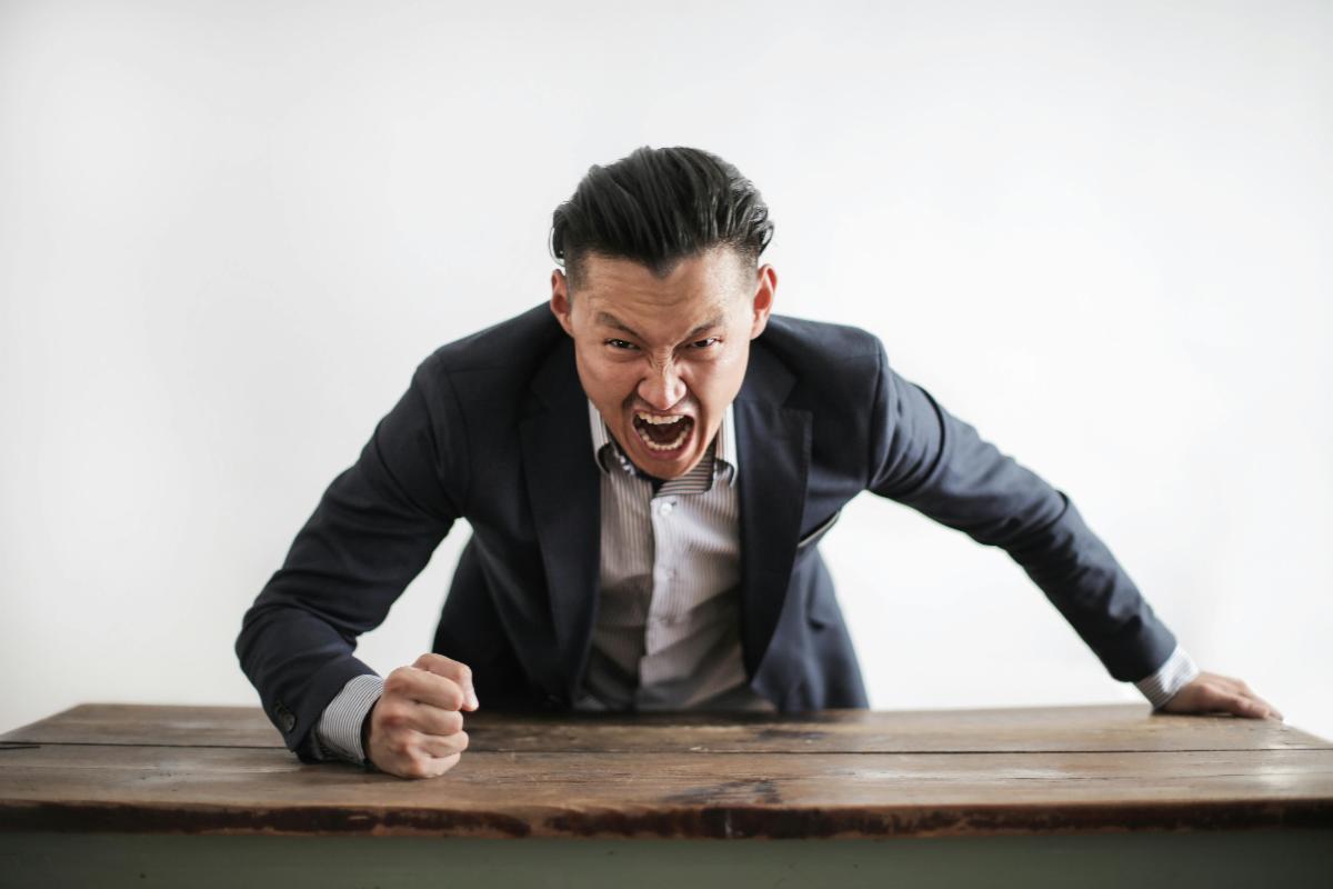 Businessman angrily shouting at camera-Feb 2025