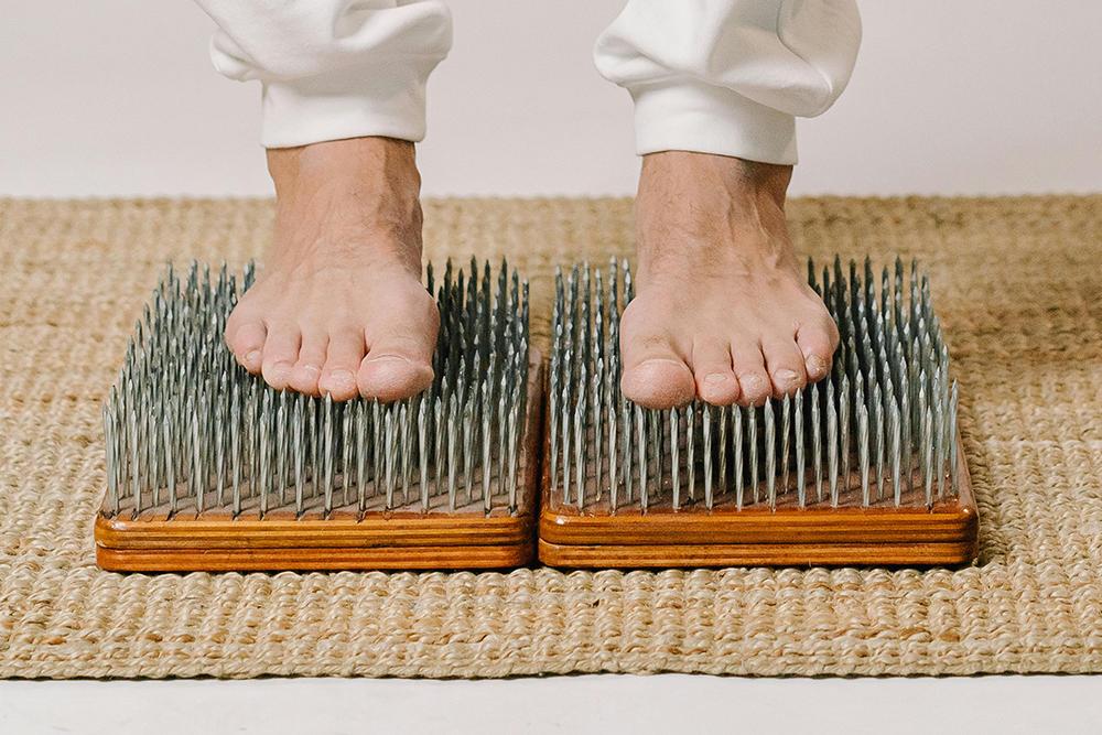Man standing on a bed of nails